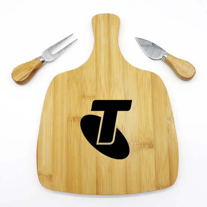 A bamboo cheeseboard with a logo and two stainless steel knives featuring wooden handles.