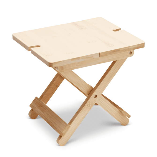 A bamboo folding table with a light wood finish and a cross-legged design, featuring cut-out handles on the top.