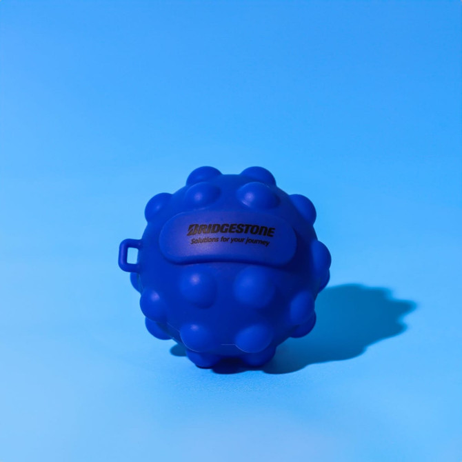 A blue stress ball with a textured surface and a small handle, featuring a logo on one side.