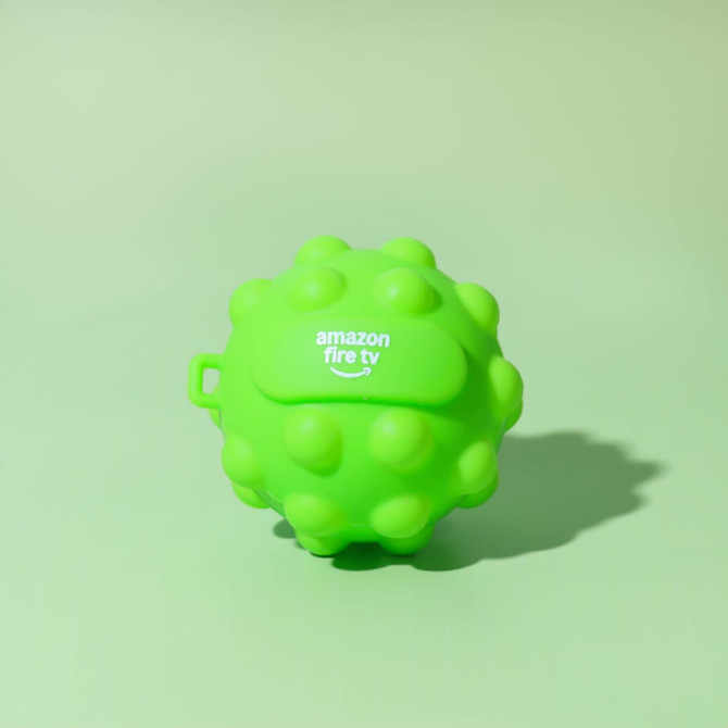 A bright green, textured stress ball with a logo, featuring a round, spiky design.
