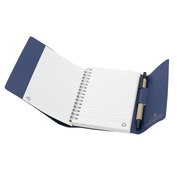 A small tuck journal book in navy blue with spiral binding and blank lined pages, featuring a holder for a pen.