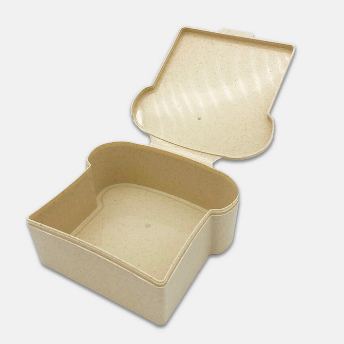 A light beige Wheat Sandwich Box with an open lid, featuring a smooth interior and a rounded shape.