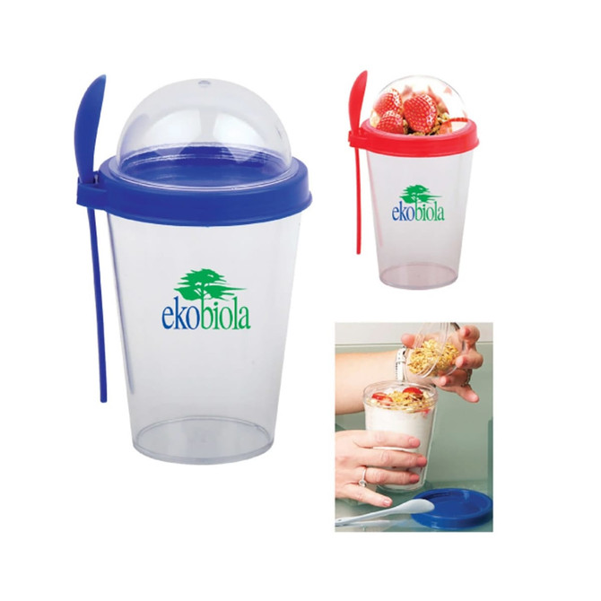 A drink bottle featuring a transparent body, blue lid, and a red spoon, with a logo present.