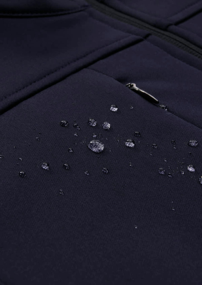 A navy men's softshell jacket with droplets of water on the fabric, showcasing its water-resistant properties.