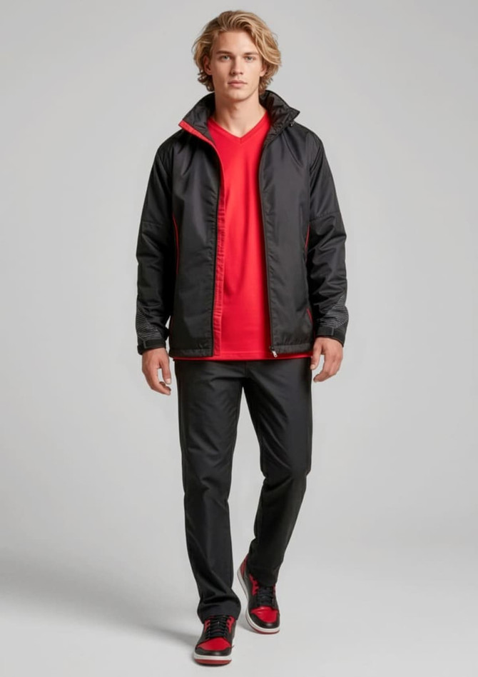 A unisex jacket in black with red accents, featuring a logo, worn over a red shirt and paired with black pants.