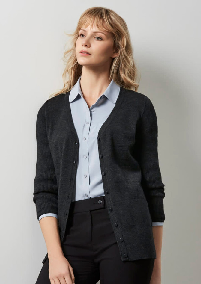 A dark charcoal cardigan with a V-neck and buttons, worn over a light blue shirt, featured on a model.