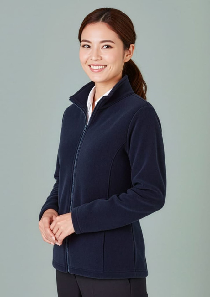 A women's plain micro fleece jacket in navy blue, featuring a zip front and a high collar, displayed on a model.