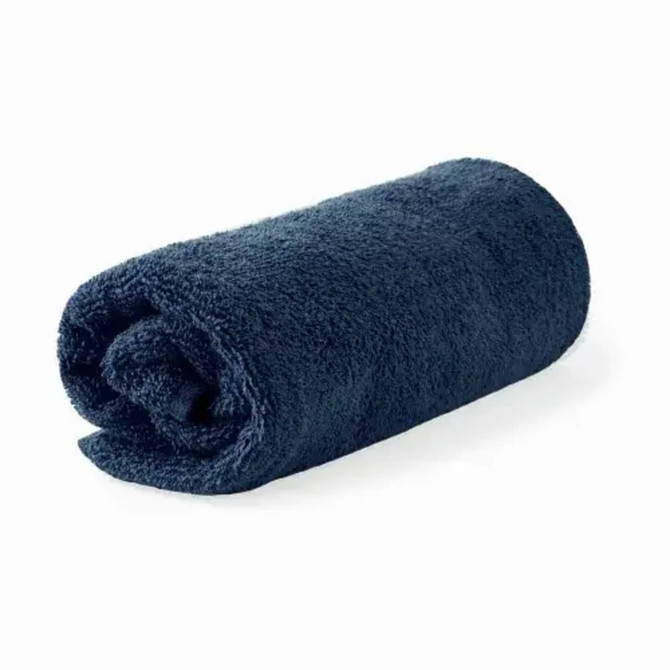 A rolled bath towel in dark navy blue, made from organic cotton, featuring a branding logo.