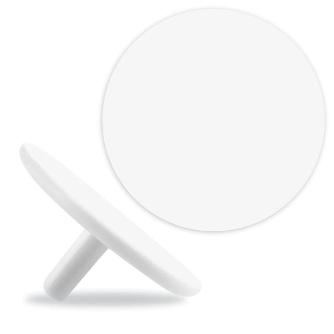 A white golf ball marker with a flat circular design and a small stem for easy placement.