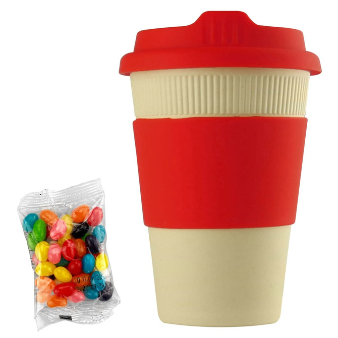 A reusable coffee cup in cream and red with a silicone sleeve, accompanied by a pack of jelly beans.