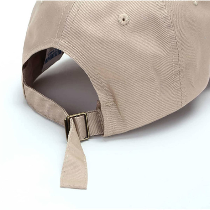 A beige cotton cap featuring a buckle strap closure and an inside branding label.