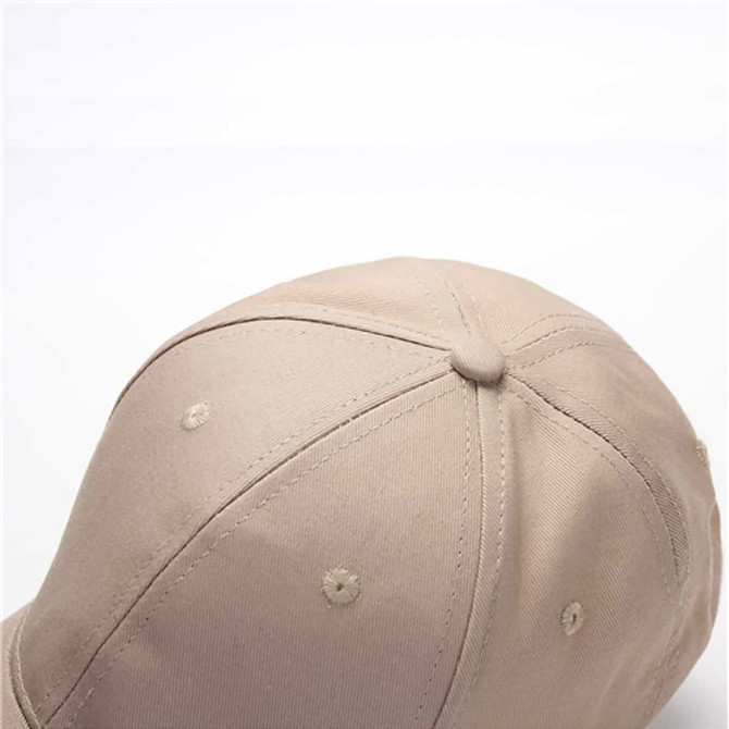 A beige cotton sandwich cap featuring six panels and a logo. The top view highlights its stitching details.
