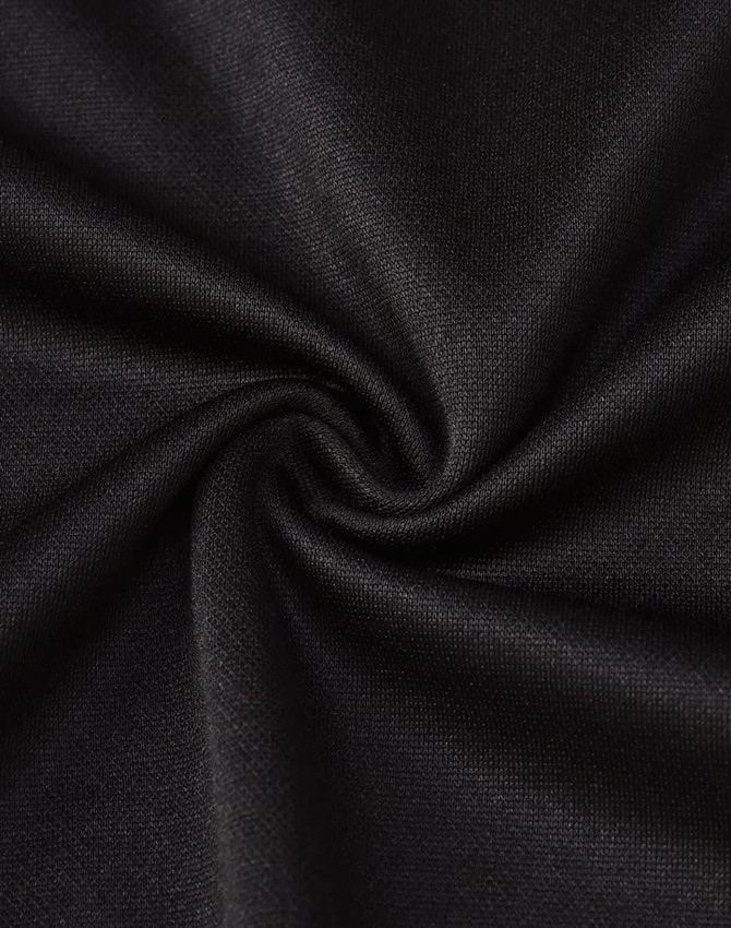 A close-up of black fabric, showcasing a smooth, textured surface suitable for a polo shirt.