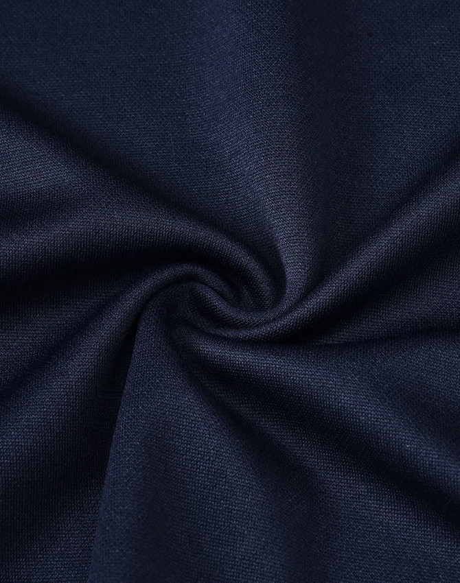A close-up of navy blue fabric, showcasing a smooth texture with a slight swirl pattern.