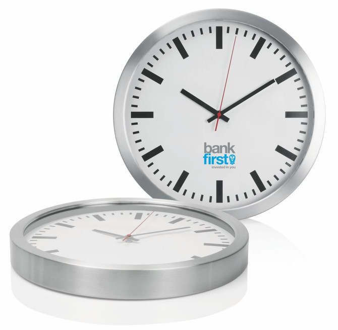 A wall clock with a silver aluminium frame, white face, black hour markers, and red second hand. Features a logo.