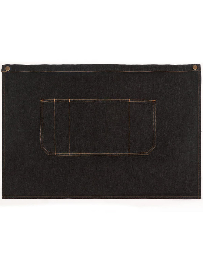 Denim half apron in dark blue with an orange-stitched pocket and a button closure. Features a logo on one side.