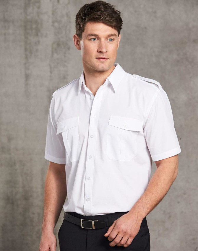 A white button-up shirt with short sleeves, featuring two front pockets and shoulder epaulettes.