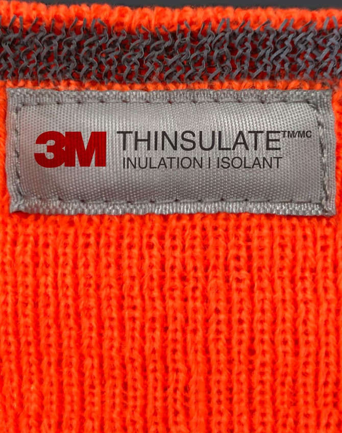 An orange Thinsulated cuff beanie with a grey label featuring branding and care information.