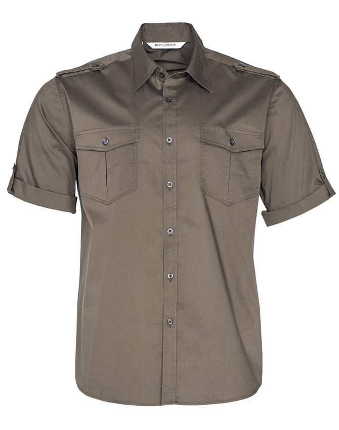 A short sleeve military shirt in olive green with two chest pockets and a button-up front. Features a logo on the label.