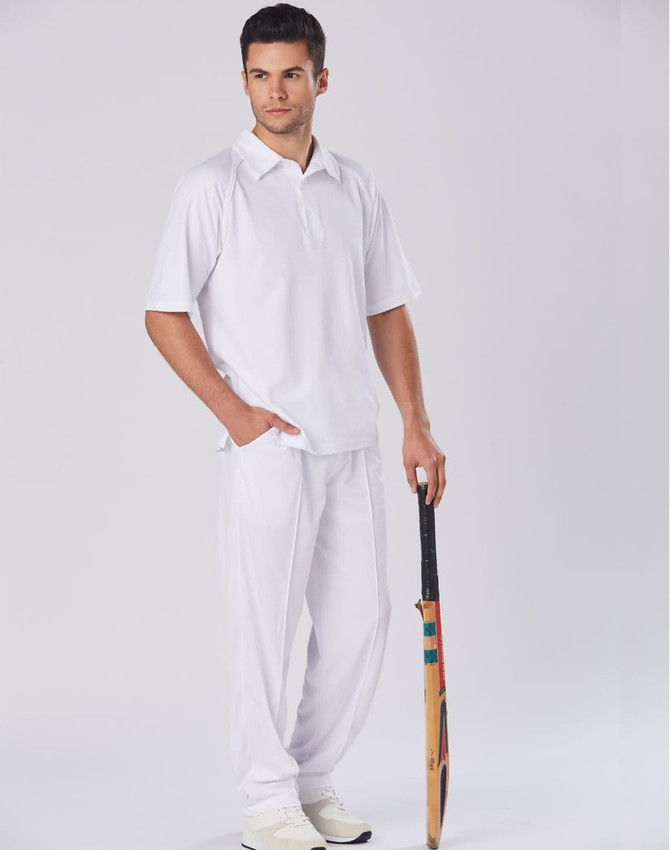 Men's cricket pants in white, paired with a matching polo shirt and holding a cricket bat. Features a logo.