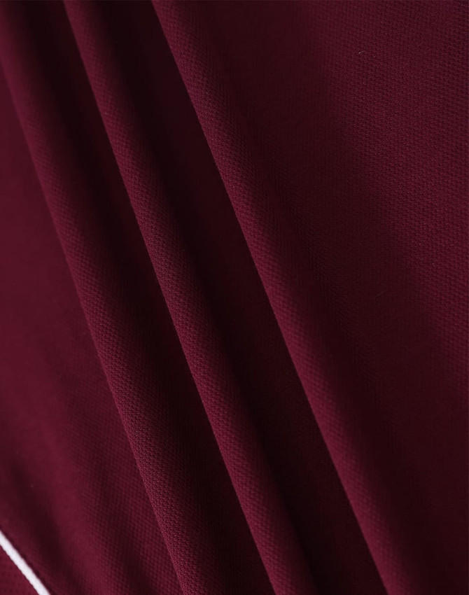 A deep burgundy polo shirt with textured fabric and a subtle logo detail.