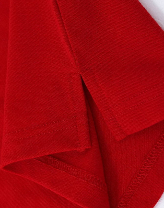A red cotton stretch polo shirt featuring neat stitching and a logo on the fabric.