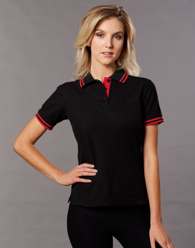 A black polo shirt with red collar and sleeve stripes, featuring a logo on the chest.