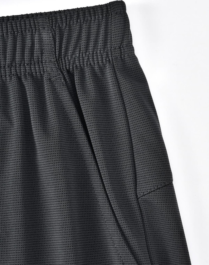 A close-up of black bamboo charcoal sports shorts featuring an elastic waistband and side pocket.