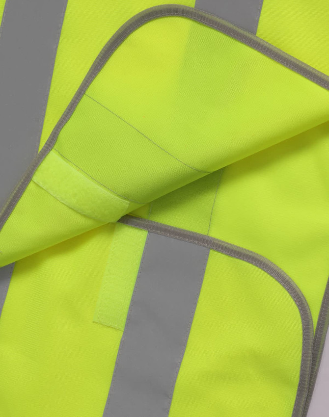 A bright yellow safety vest with grey reflective shoulder tapes, featuring contrast stitching and a soft inner lining.