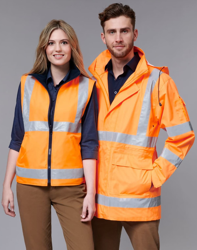 A safety jacket in bright orange with reflective stripes, displayed on two models, one male and one female.