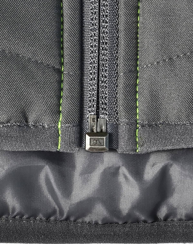 A quilted grey safety jacket with reflective stitching and a zipper detail at the front, including a logo.
