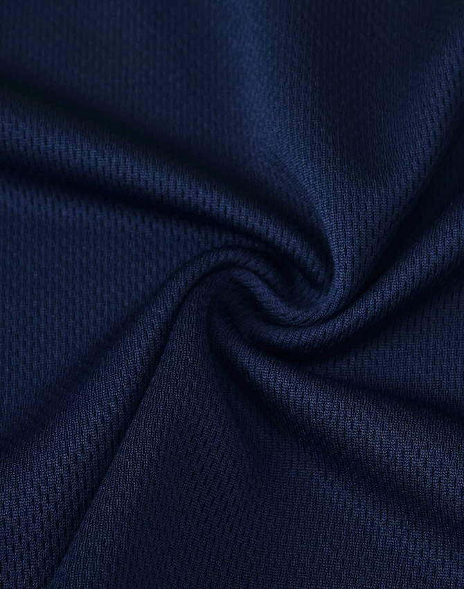 A close-up of navy fabric with a textured pattern, suitable for polo shirts. The material appears breathable and flexible.