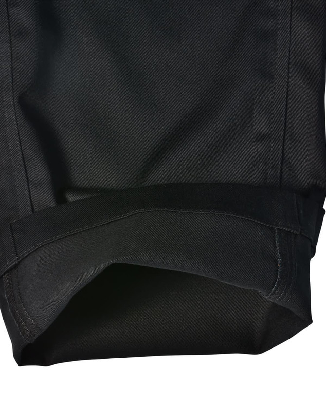 A pair of black cargo pants showcasing a folded cuff, featuring a durable fabric and a branded label.
