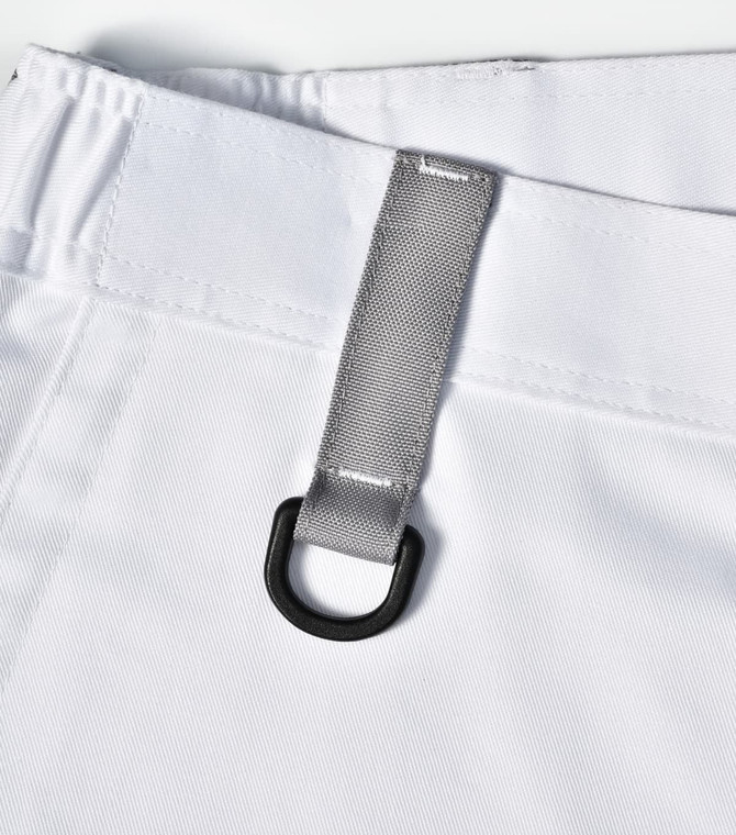 A close-up of a white unisex utility stretch cargo work pant featuring a silver loop and waistband detail.