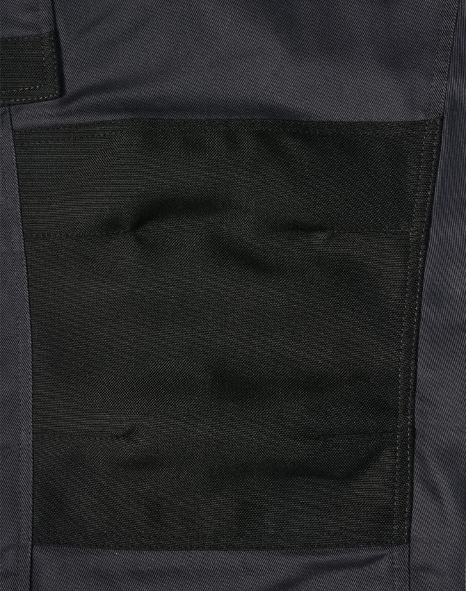 A close-up of black utility cargo work pants featuring a large pocket on the thigh area.