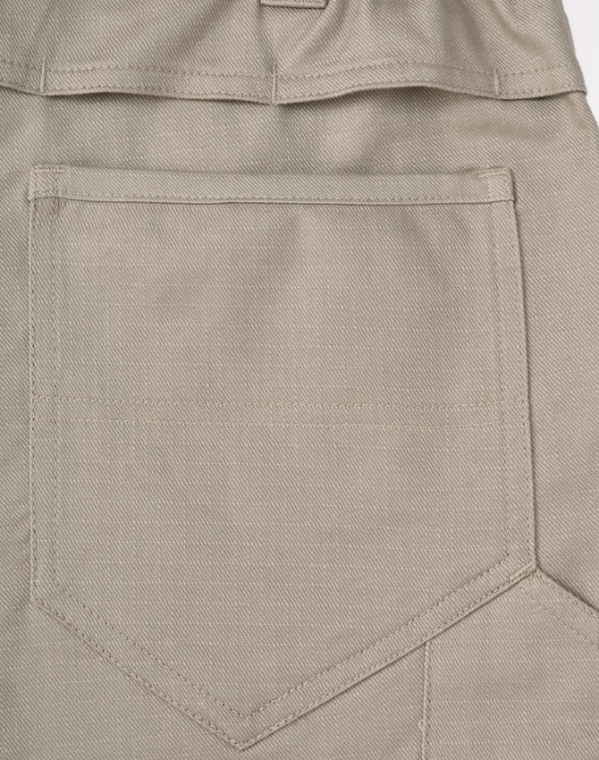 A close-up of khaki unisex cotton stretch ripstop work pants with a back pocket design and a logo.