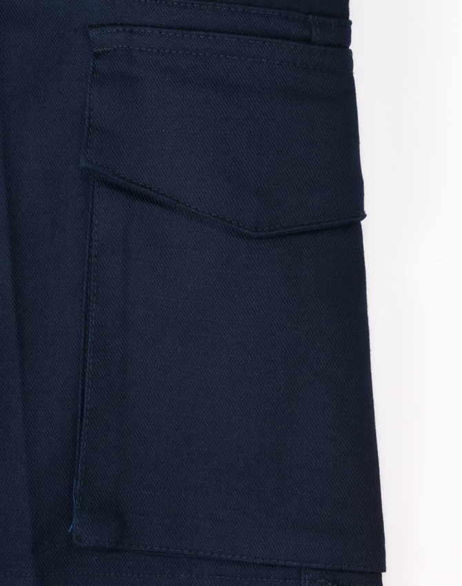 A close-up of navy work shorts featuring a pocket and a logo. The fabric appears durable and stretchy.