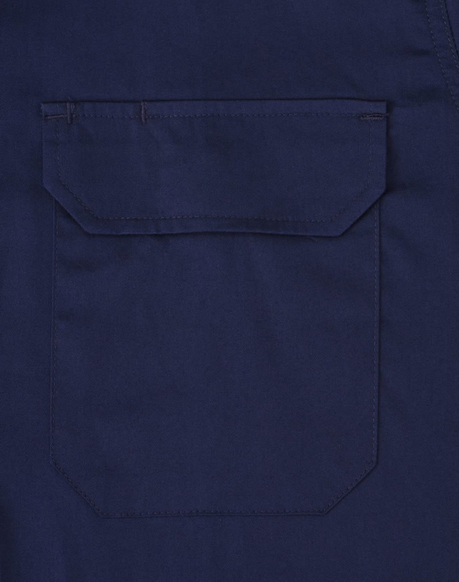 A navy long-sleeve work shirt featuring a closed front and a pocket on the back. The shirt has a branding logo.