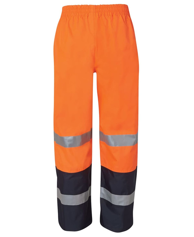 Premium rain pants in bright orange with reflective silver stripes and navy accents. Elastic waistband for comfort.