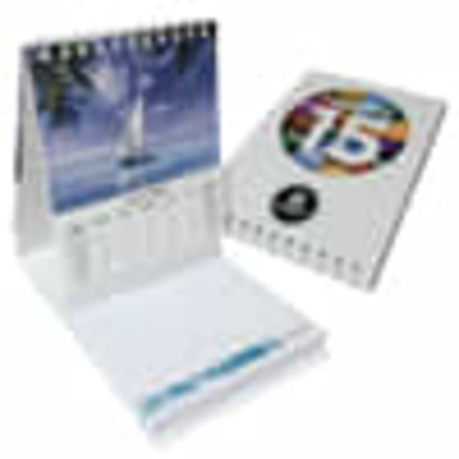 A compact, multi-coloured desk calendar with a ring binding and an image of a sailboat. It includes a notepad section.