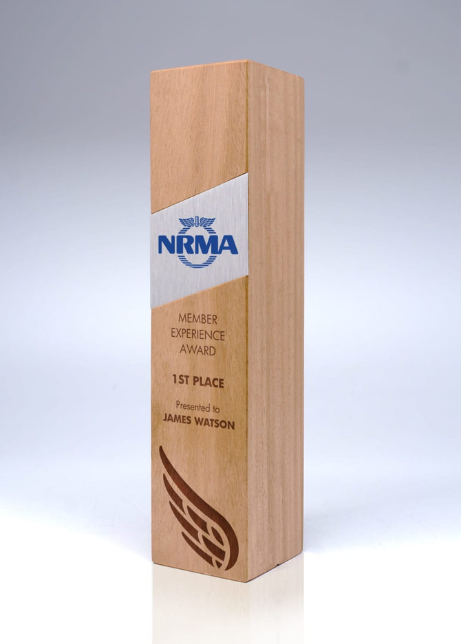 A wooden trophy in light brown, featuring a sleek design and a logo. It has a rectangular shape and a polished finish.