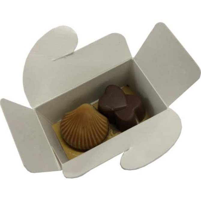 A white box containing two assorted chocolates: one shell-shaped and one heart-shaped, both in brown hues.
