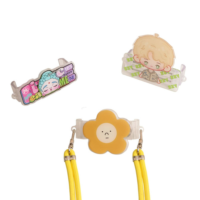 An adjustable phone lanyard with a yellow flower clip and two decorative attachments in various colours.