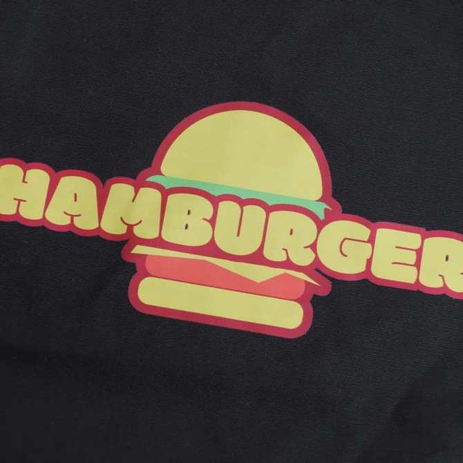 A black apron featuring a colourful hamburger graphic with the word "HAMBURGER" in bright, bold letters.