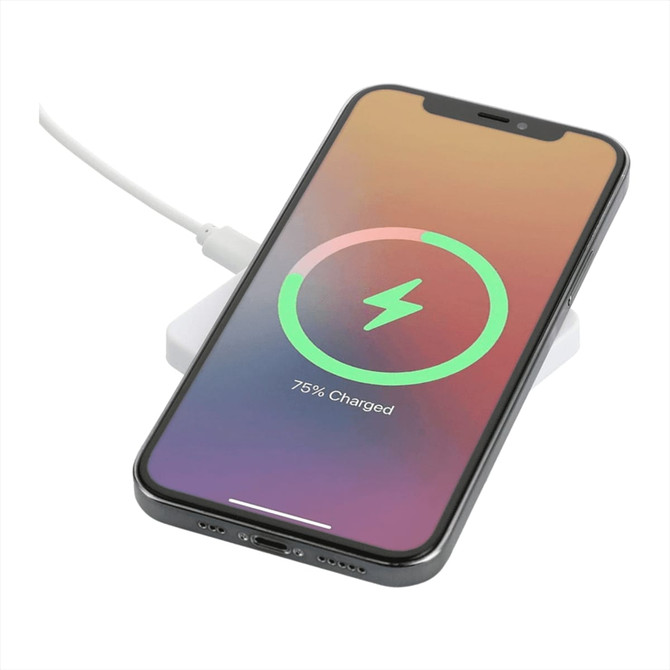A square white wireless charging pad with a smartphone displaying a charging status indicator.
