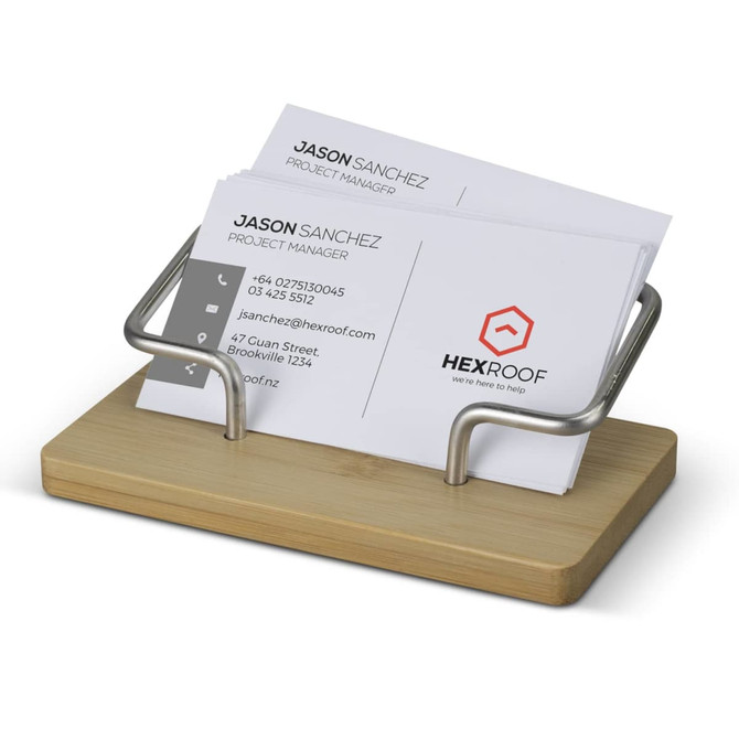 A bamboo business card stand with a silver metal holder, displaying several business cards in a neat arrangement.