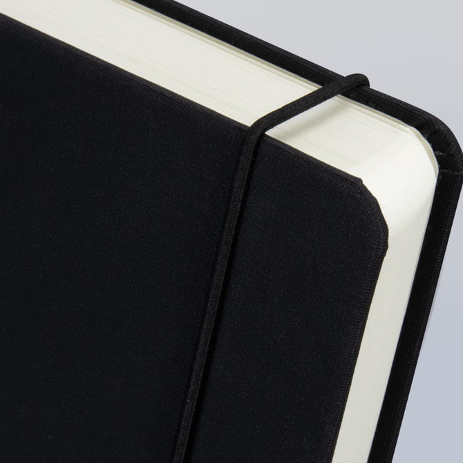 A black diary with a textured cover and an elastic band holding it closed, featuring cream-coloured pages.