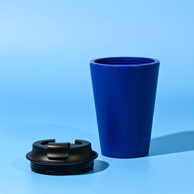 A blue reusable coffee mug with a black lid, made from recycled materials.