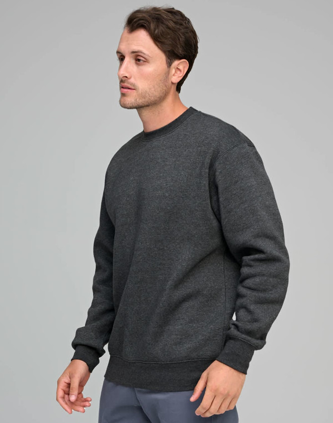 A man wearing a dark grey crew fleece sweatshirt, featuring a relaxed fit and ribbed cuffs.