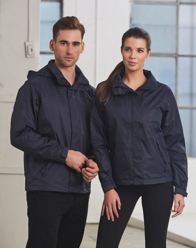 A navy blue versatile jacket worn by a man and a woman, featuring a hood and a branding logo.